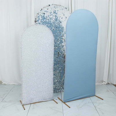 Two stylish backdrop stands, one sparkly silver and one soft blue, in a studio setting.