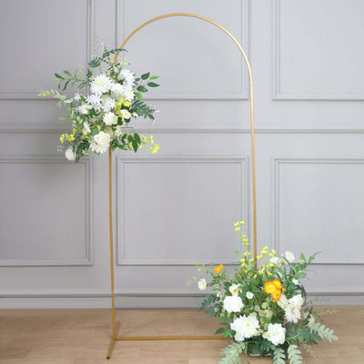 Gold floral arch with white and yellow flowers, green foliage, and a decorative base.
