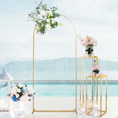 Elegant wedding arch with floral arrangements by a poolside setting.