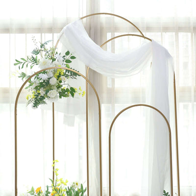 Elegant floral arch with draped fabric for events and decor.
