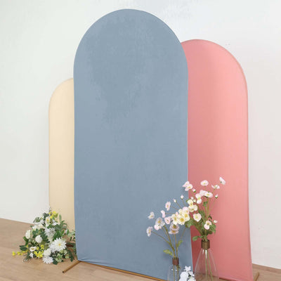 Three arched backdrops in blue, pink, and beige with flowers in front.