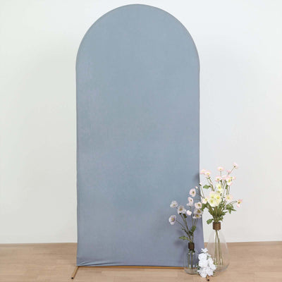Gray fabric backdrop with a rounded top and decorative vases of flowers.
