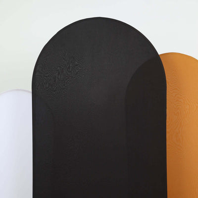 Three fabric backdrops in black, white, and orange for photography use.