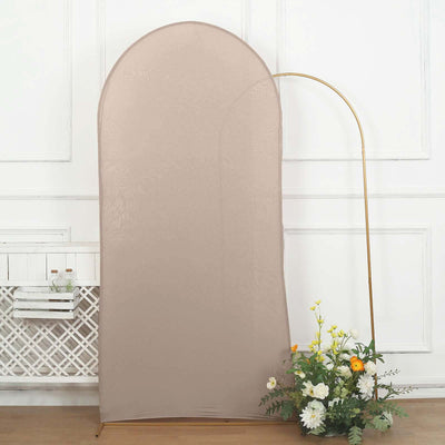 Neutral fabric backdrop with an arch shape and decorative flowers