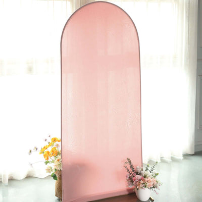 Pink backdrop with floral arrangements for photography.