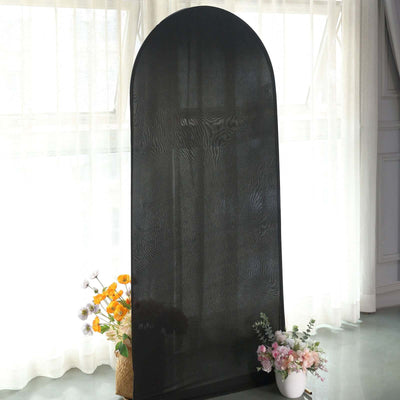 Black arch-shaped room divider with floral arrangements in a bright interior setting.