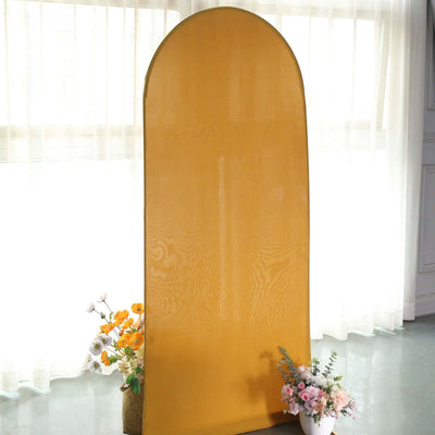 Yellow arch-shaped backdrop with floral arrangements in a bright room.