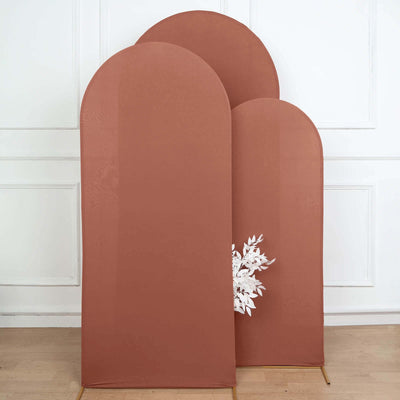 Three arch-shaped fabric panels in warm terracotta with a floral design.