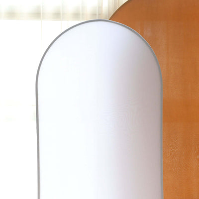 Minimalist curved backdrop in soft white and warm tones.