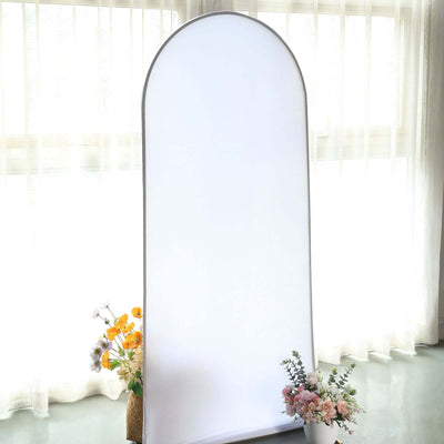Studio backdrop with floral arrangements in front.