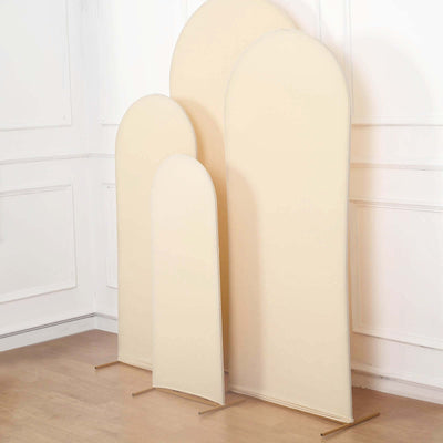 Three beige arch-shaped display stands in varying heights.