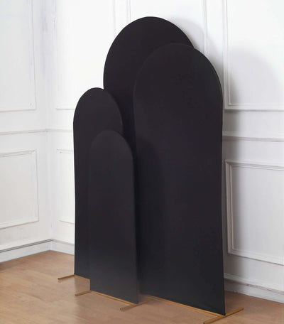 Set of three black decorative panels on a wooden floor.