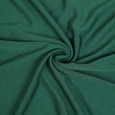 Green fabric with a soft texture, ideal for various sewing projects.