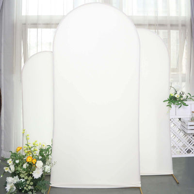 Three tall white backdrops with floral arrangements in front