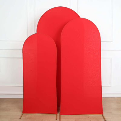 Three red fabric display stands in varying heights against a plain background.