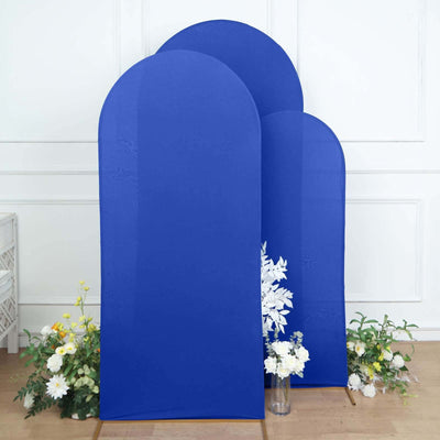 Blue arch-shaped backdrops with floral accents in a studio setting.