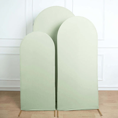 Set of three green arch-shaped fabric screens on a light wood floor.