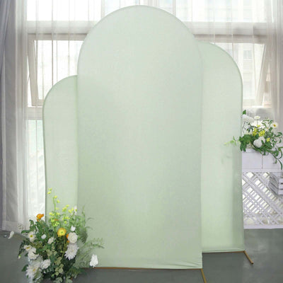 Green backdrop panels with floral arrangement in a studio setting.