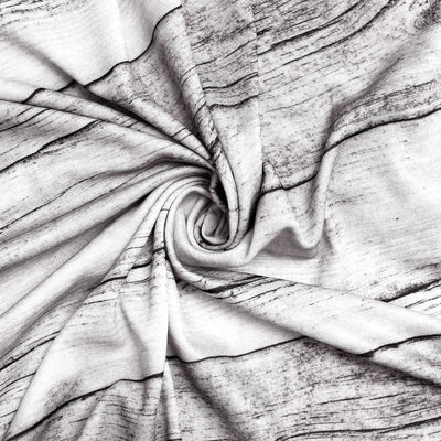 Swirled fabric showcasing a wood grain pattern in black and white.