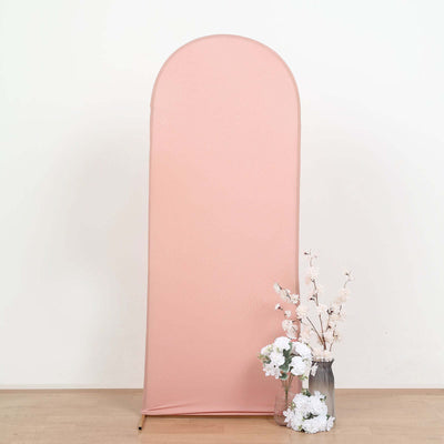 Pink backdrop with artificial flowers in a vase, studio-style shot.