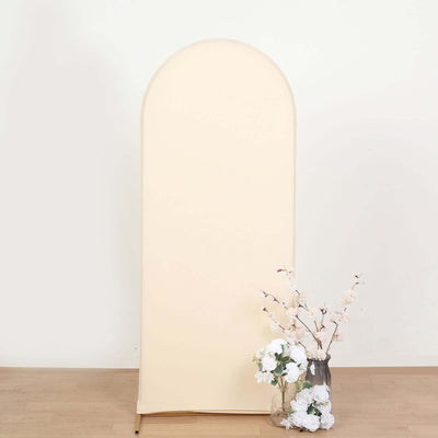 Cream arched backdrop with floral arrangement in vase