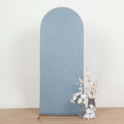 Blue arch backdrop with floral arrangement in front.