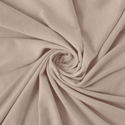 Light beige stretchy fabric swirling in a spiral pattern.