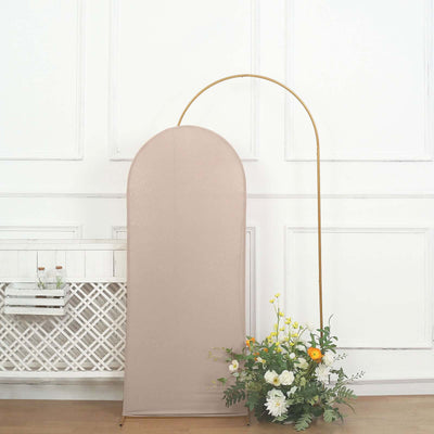 Neutral fabric backdrop with golden arch and floral arrangement.