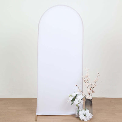 White fabric backdrop with decorative flowers in a vase.
