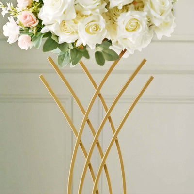 Gold flower stand with white and pink roses on top.
