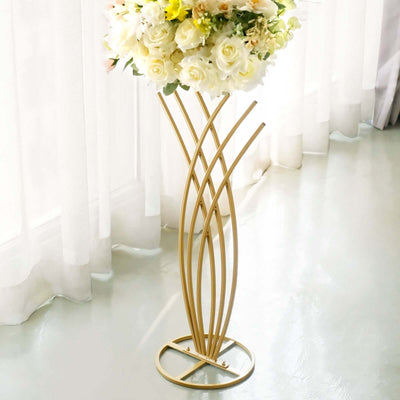 Elegant gold flower stand showcasing a bouquet of roses and lilies.