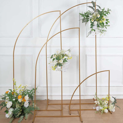 Gold floral display stand with various flowers and greenery.