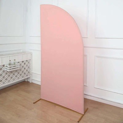 Pink curved backdrop stand with gold base in a styled interior setting.