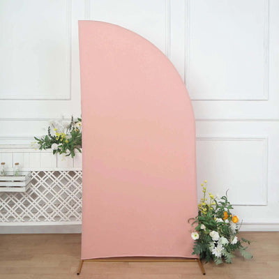 Pink curved backdrop with floral accents in a studio setting.