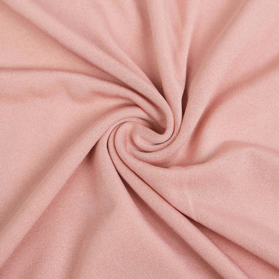 Soft pink fabric with a smooth texture, elegantly draped in a swirl.