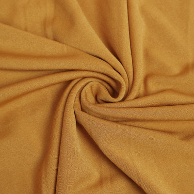 Close-up of soft mustard yellow fabric with a smooth texture.