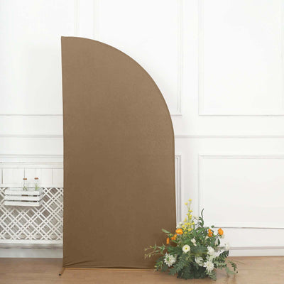 Brown half-circle backdrop with floral arrangement on the floor
