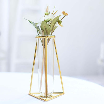 Gold geometric vase with flowers, elegantly displayed in a minimalist style.