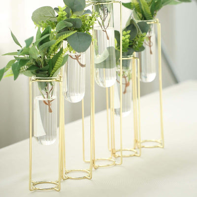 Gold metal vase stand with glass tubes and greenery