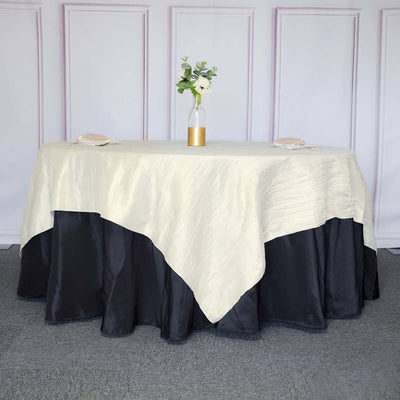 Elegant tablecloth with cream top and black bottom drape on a styled table.