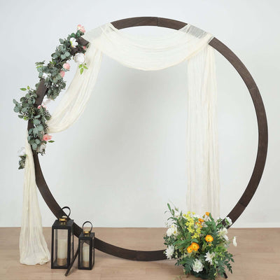 Decorative circle backdrop with drapes, flowers, and lanterns for events
