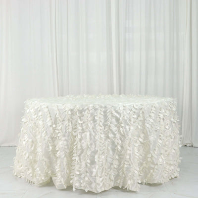White tablecloth with floral design draping over a round table