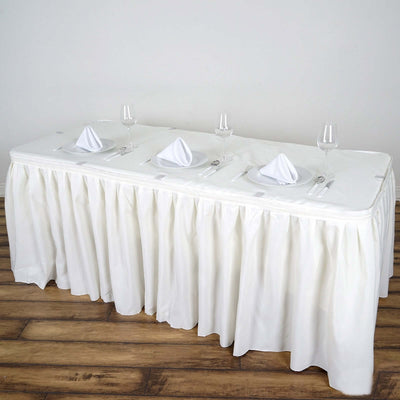 White tablecloth draped elegantly on a banquet table set for dining.