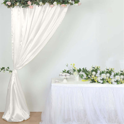 Elegant white drapery with floral arrangement on a table