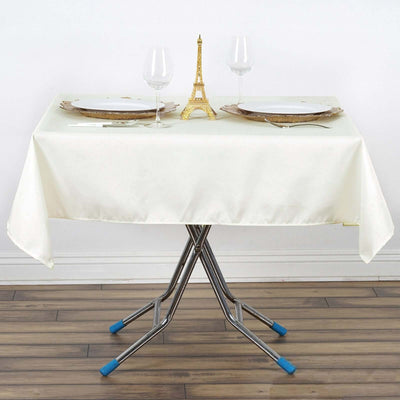 Elegant dining setup with table, plates, glasses, and Eiffel Tower centerpiece.