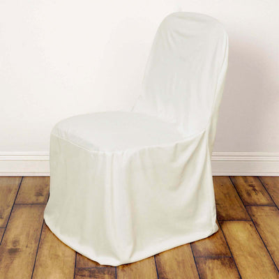 White chair cover draped over a chair on a wooden floor.