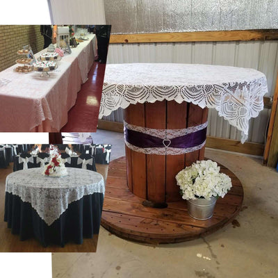 Decorated tables with lace tablecloths at an event venue.