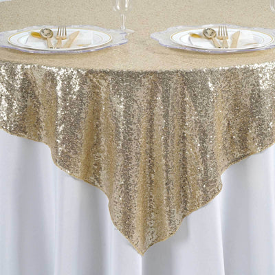Gold sequin tablecloth draping elegantly over a white table.