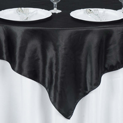 Black satin tablecloth draping elegantly over a white table.