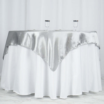 Elegant silver tablecloth draped on a round table for events and parties.